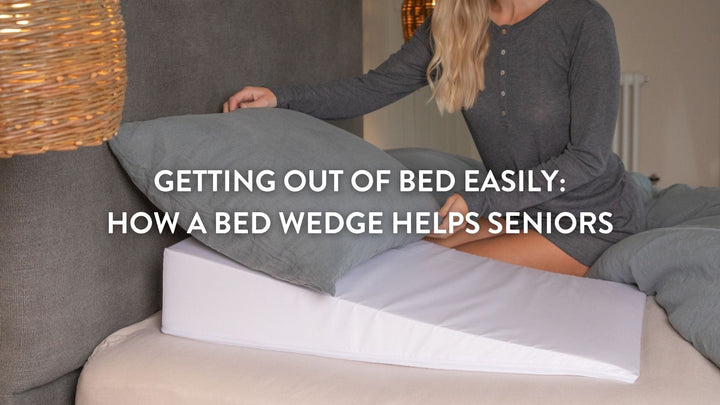 Person arranging a pillow on top of a bed wedge pillow on a large double bed