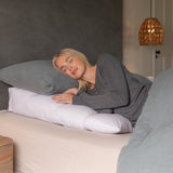 Woman sleeping on her side on a bed wedge